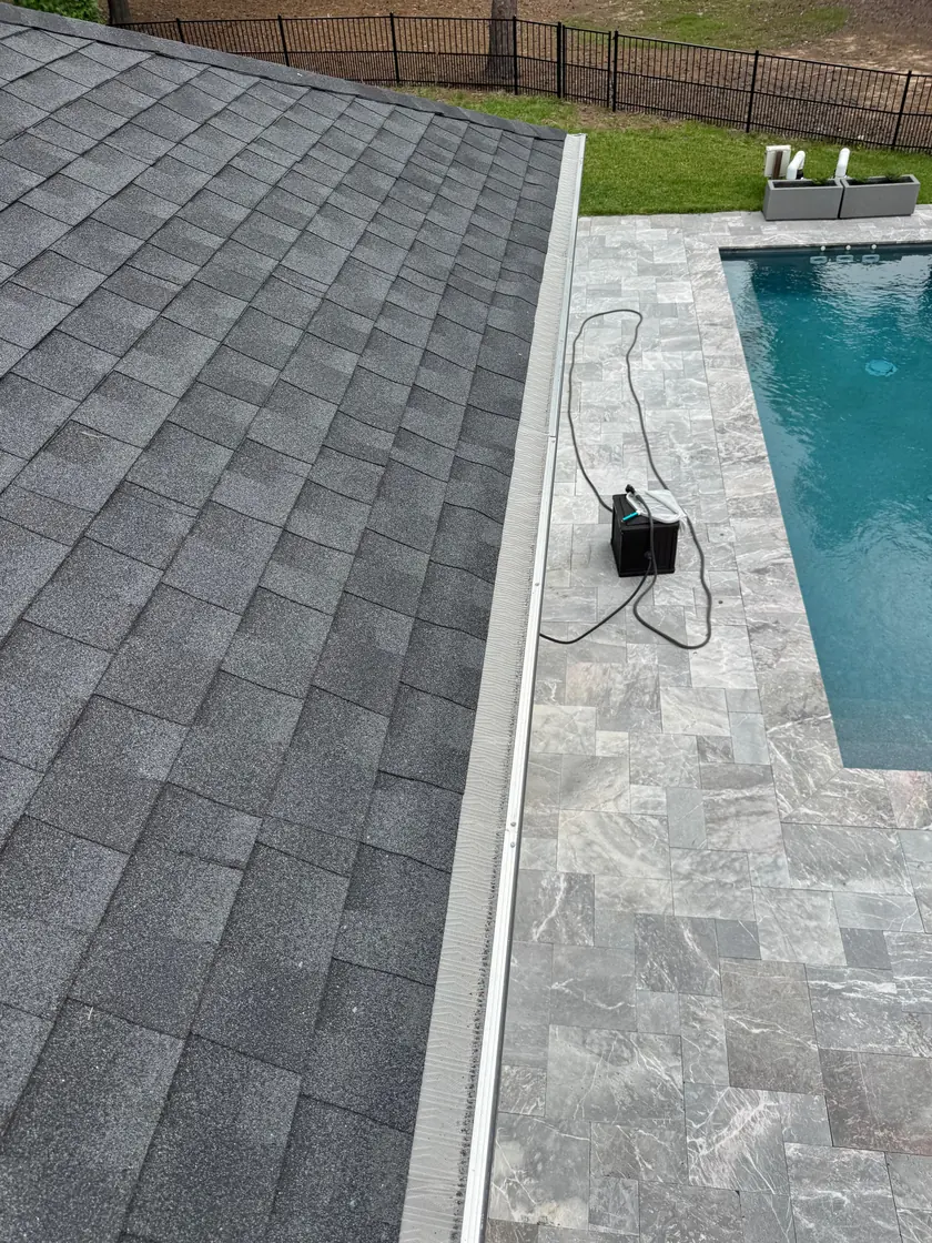 Long run of micromesh gutter guard installed along a roofline beside a pool